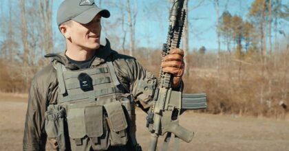 Blue Jean Operator holding rifle and waring the MBAV for review